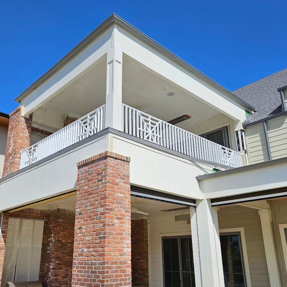 A house with a balcony and a brick chimney