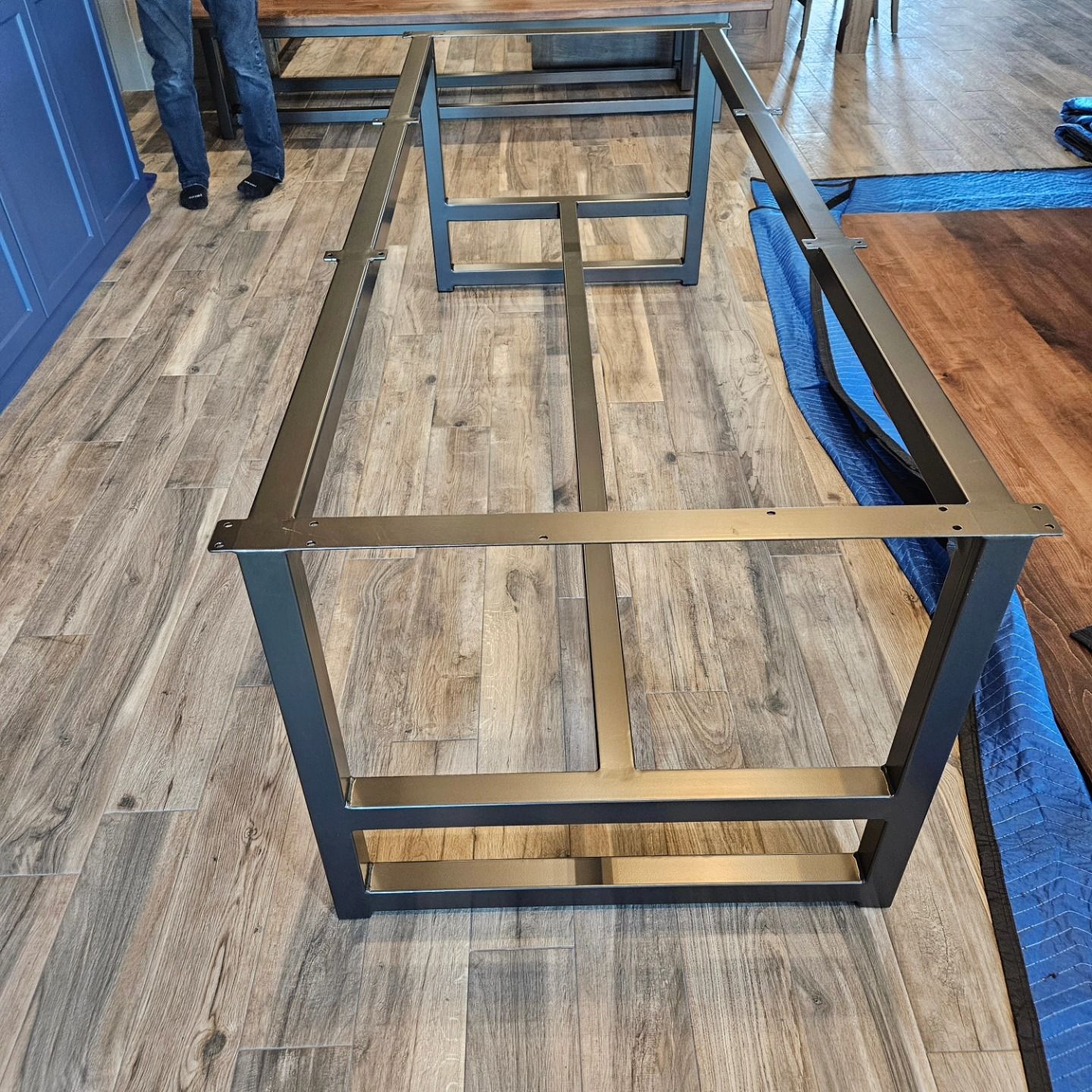 A metal frame is sitting on a wooden floor