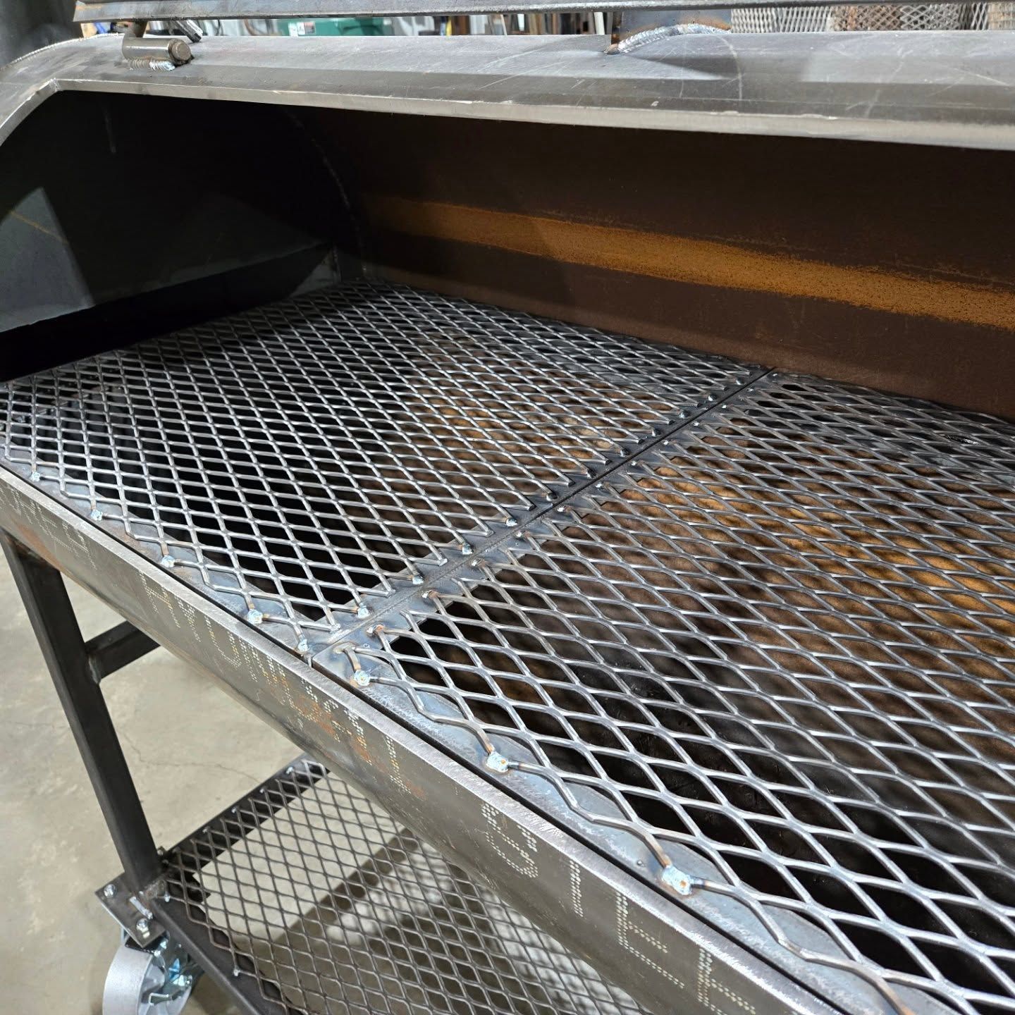 A grill with a metal grate on top of it