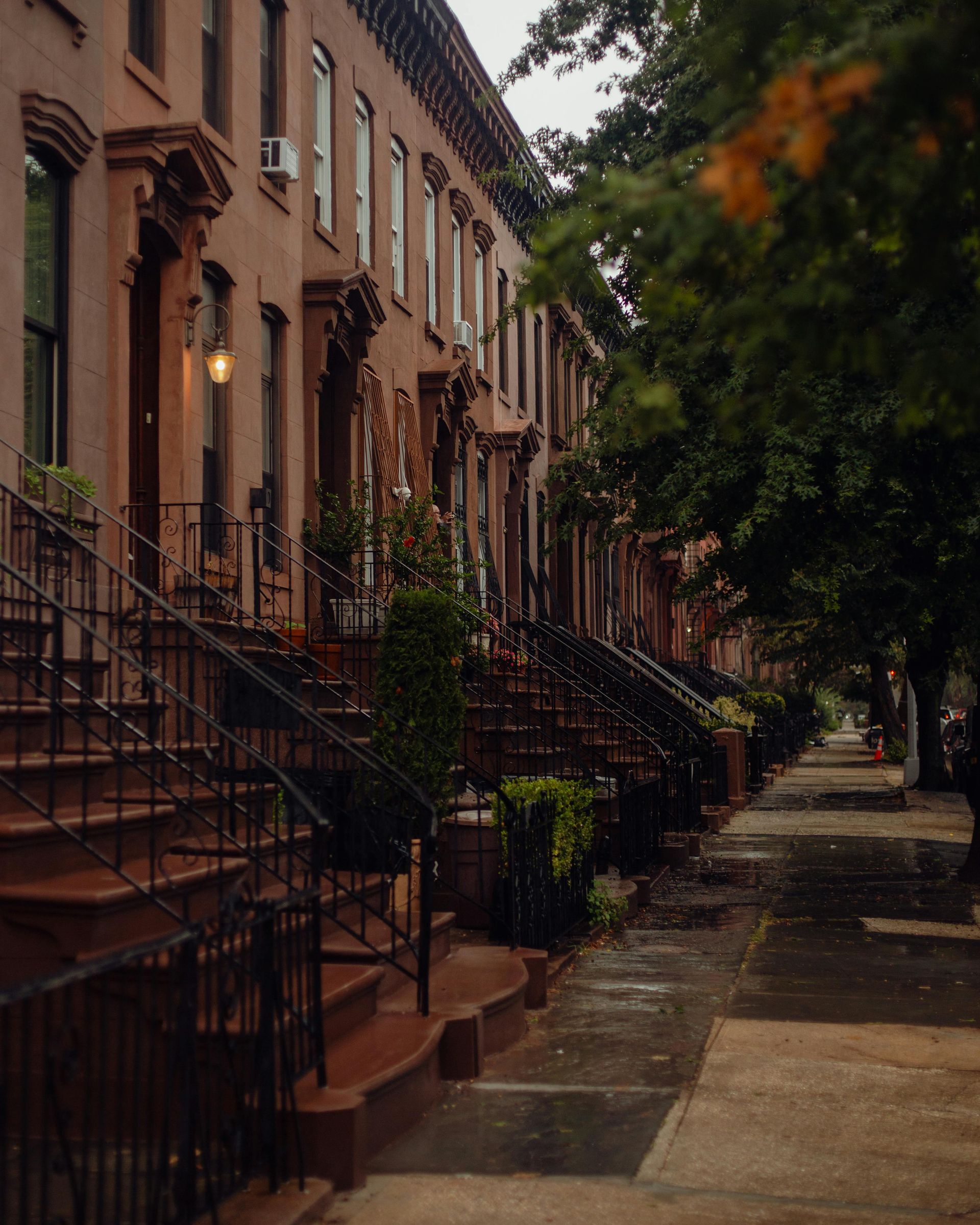 A row of brick buildings with stairs leading up to them