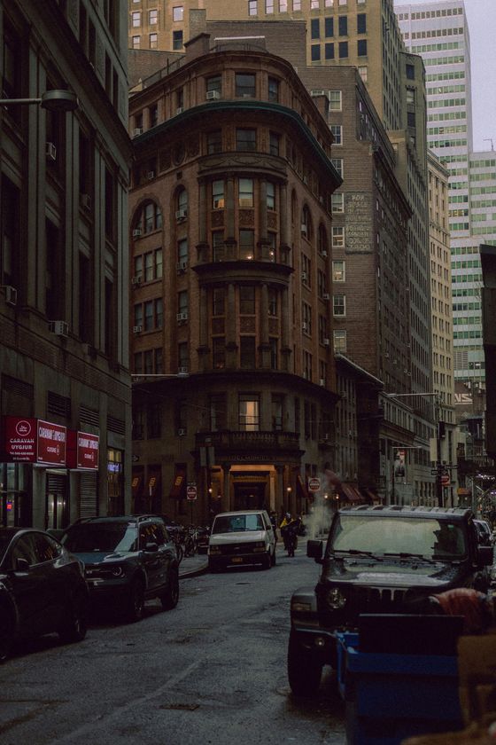 A busy city street with cars parked on the side of it