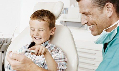 Dentist and Young Boy - Teeth Cleaning in Pleasant Hill, MO