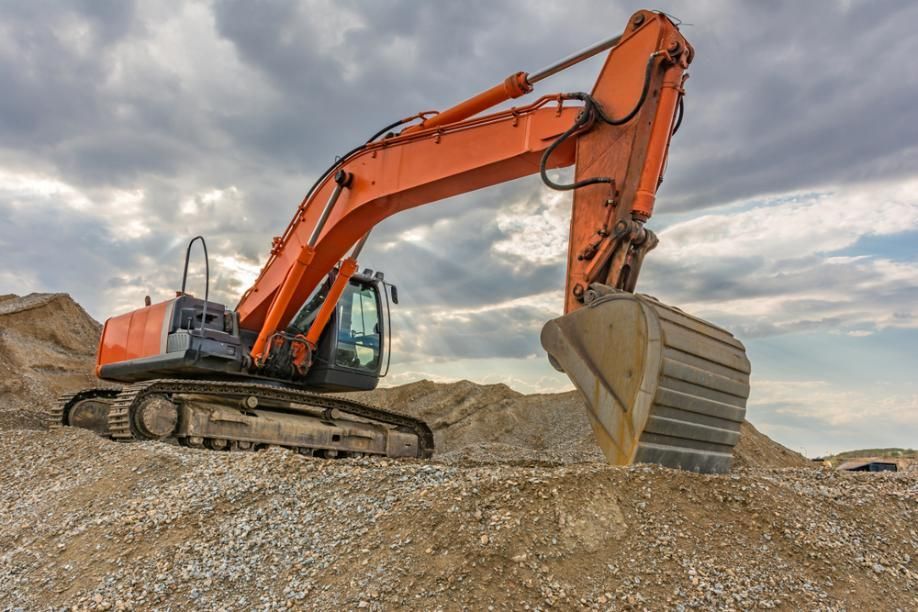 A Large Orange Excavator is Sitting on Top of a Pile of Dirt — Zappala Quarries in Innisfail, QLD