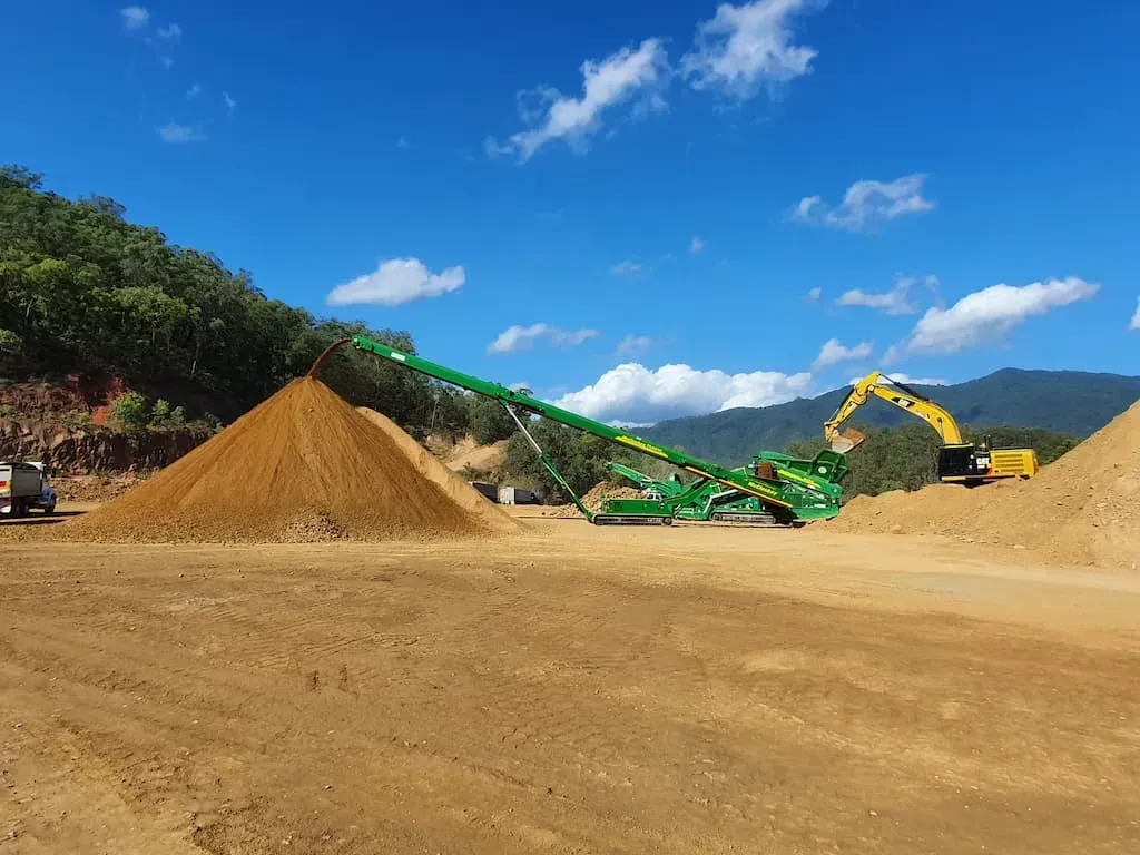 A Large Pile of Dirt Is Sitting in The Middle of A Dirt Field — Zappala Quarries in Gordonvale, QLD