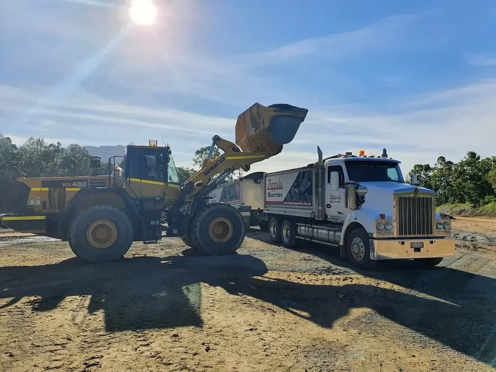 A Bulldozer Is Loading a Truck on A Dirt Road — Zappala Quarries in Gordonvale, QLD