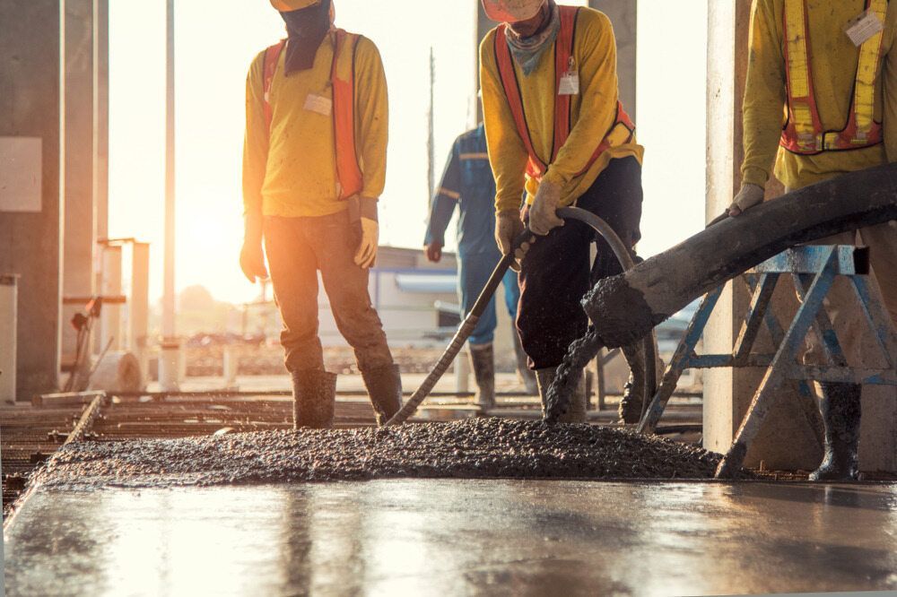 Construction Workers Pouring Concrete on A Floor, Wearing Safety Vests, at A Construction Site — Zappala Quarries in Innisfail, QLD