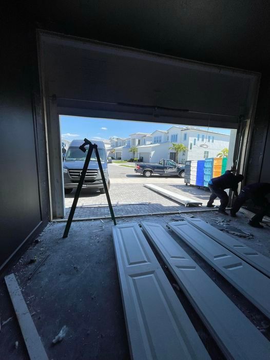 A man is working on a garage door.