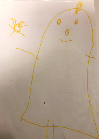 a child 's drawing of a ghost with a yellow face on a piece of paper .