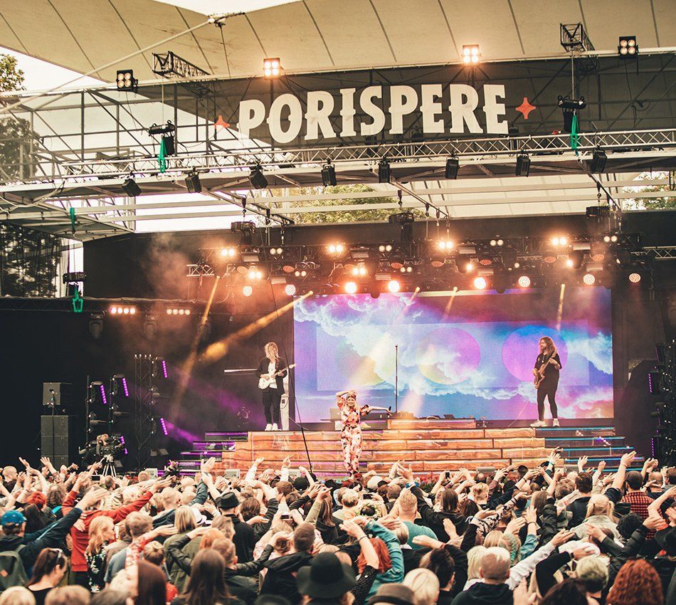 a large crowd of people are watching a concert at Porispere