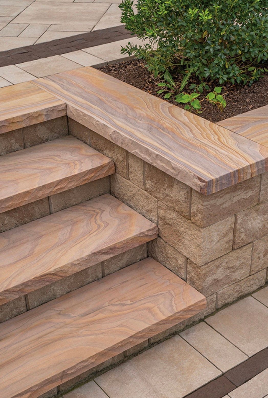 Stone steps with a planter box alongside, built into a walkway.