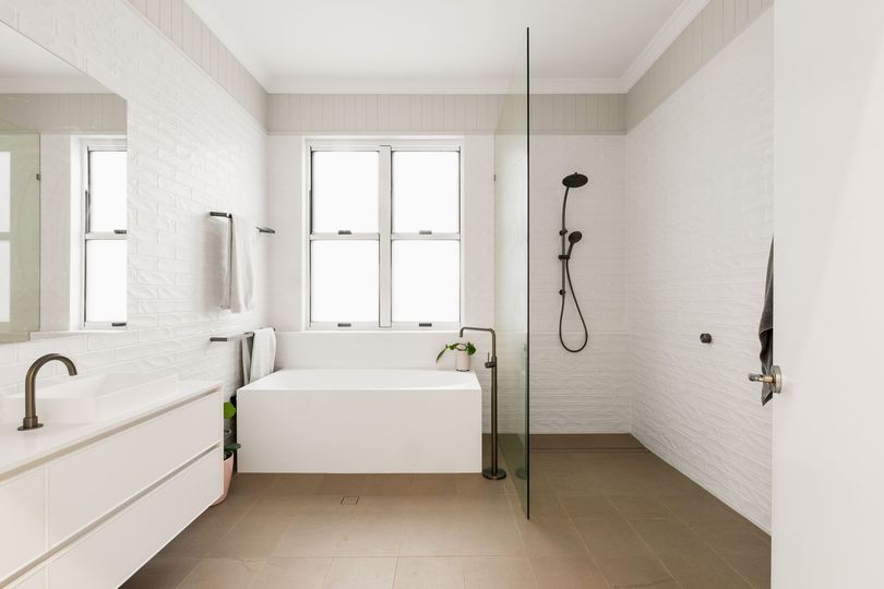 A Bathroom With White Cabinets and Drawers and a Brick Wall — Halls Cabinets & Joinery in Harlaxton, QLD