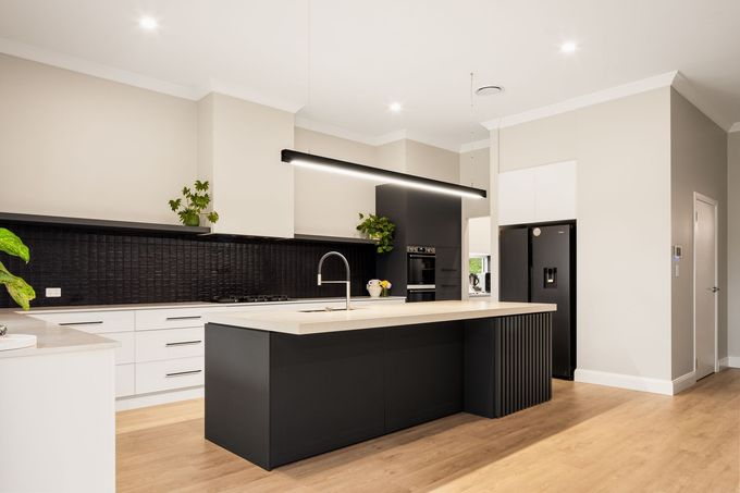 A Kitchen With White Walls, Black Cabients and Wooden Floors — Halls Cabinets & Joinery in Harlaxton, QLD