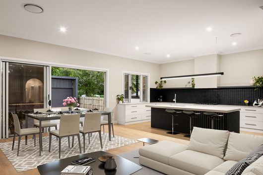 A Kitchen With White Cabinets,a wide window and dining table — Halls Cabinets & Joinery in Harlaxton, QLD