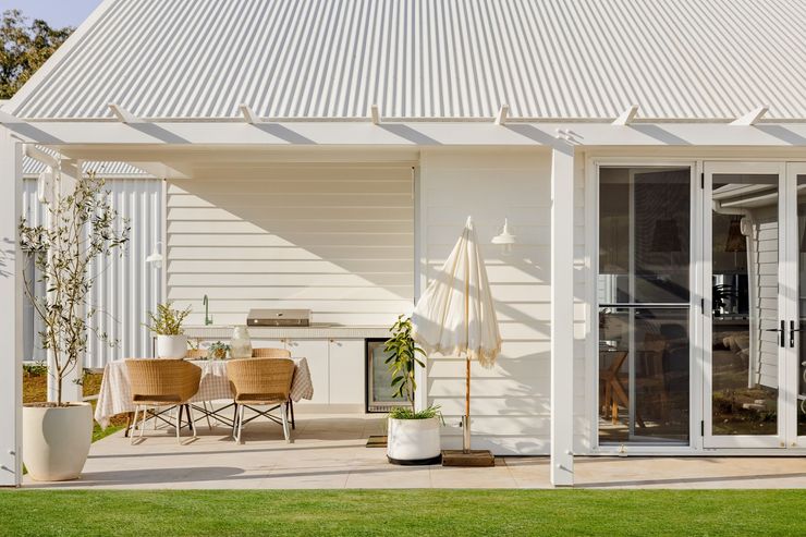 Outside Kitchen with Dining Table and white cabinets   — Halls Cabinets & Joinery in Harlaxton, QLD
