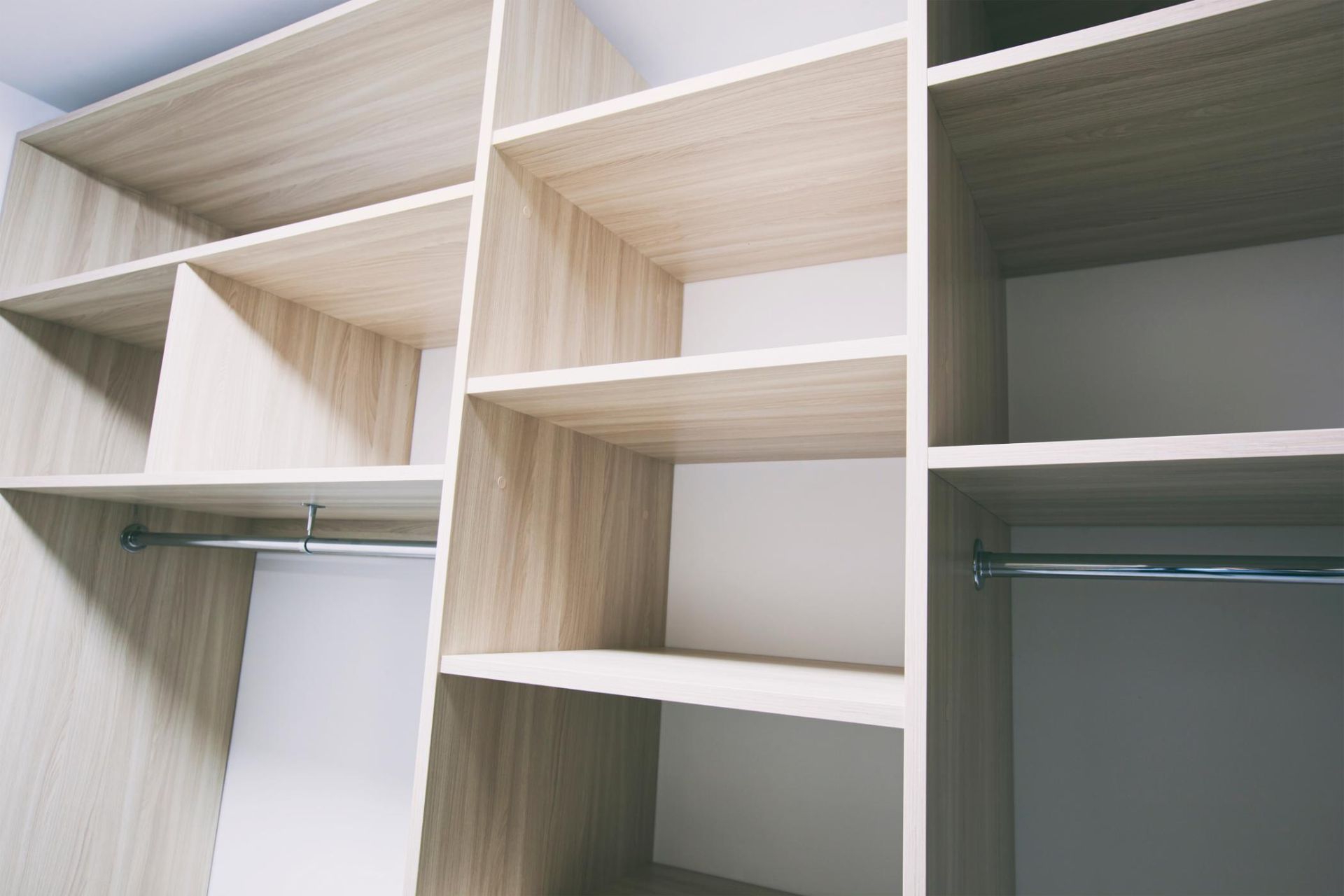 Empty Walk in Closet With Wooden Cabinets — Halls Cabinets & Joinery in Harlaxton, QLD