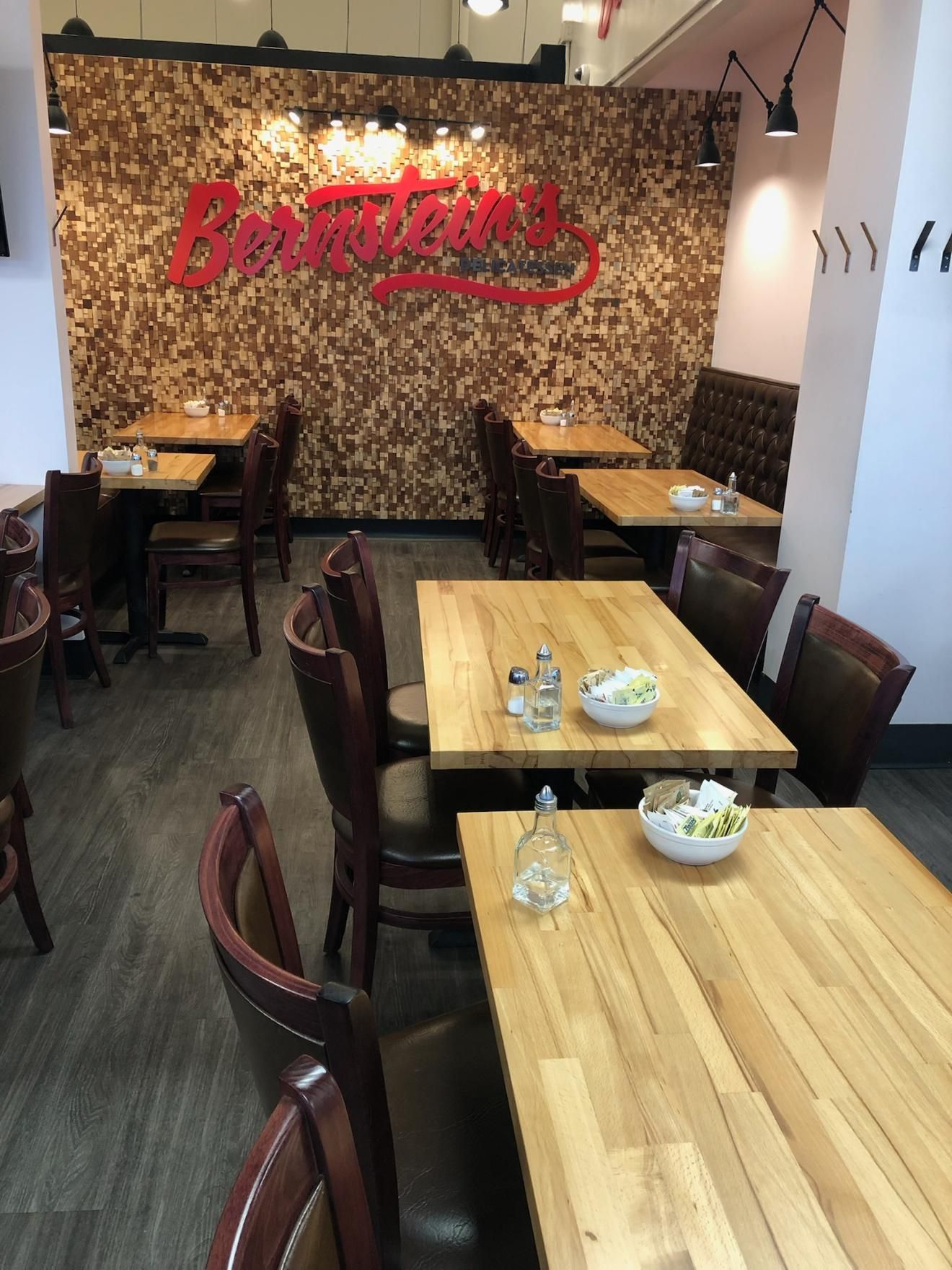 An empty restaurant with tables and chairs set for dinner