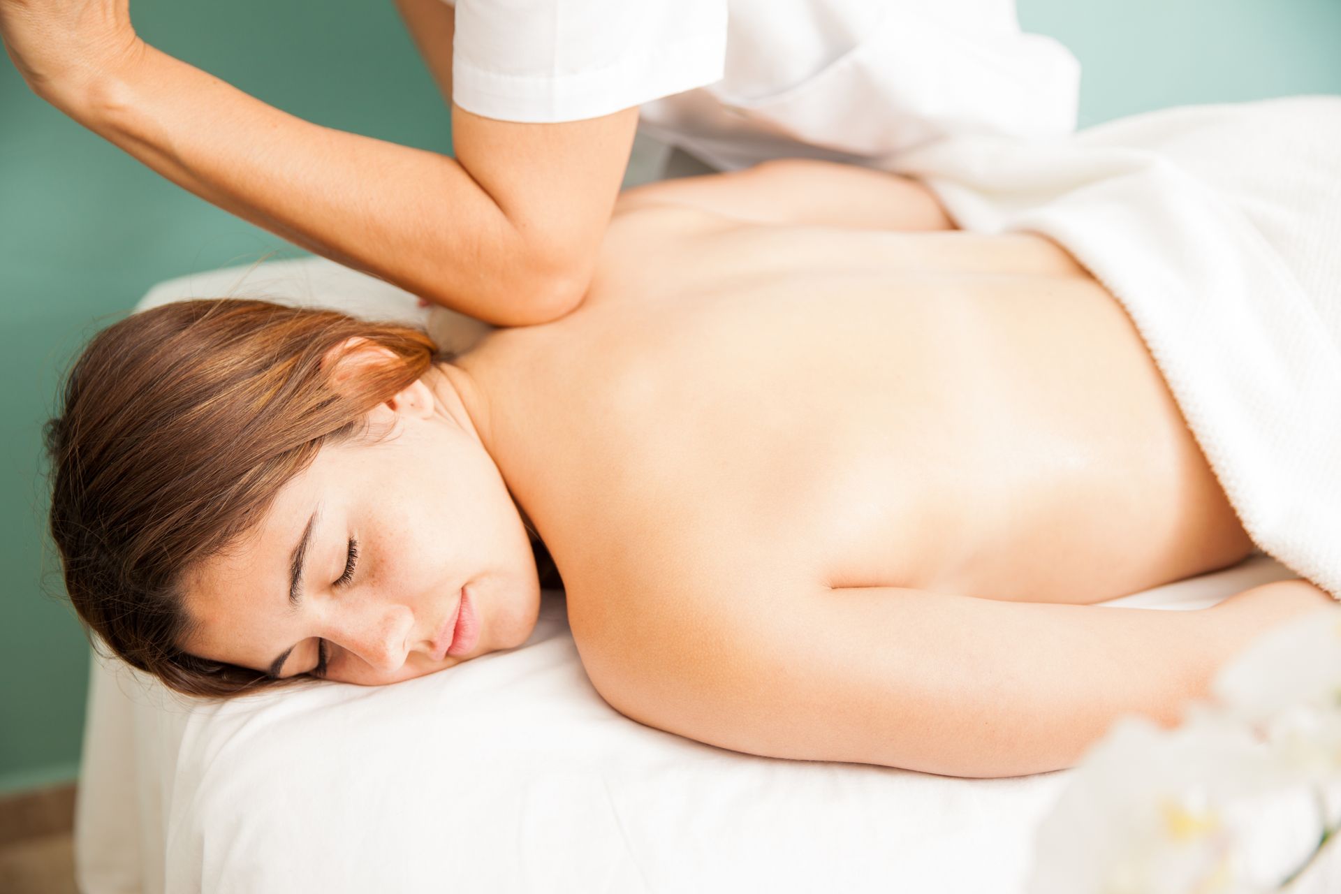 A beautiful young woman is getting a deep tissue massage A beautiful young woman is getting a deep tissue massage