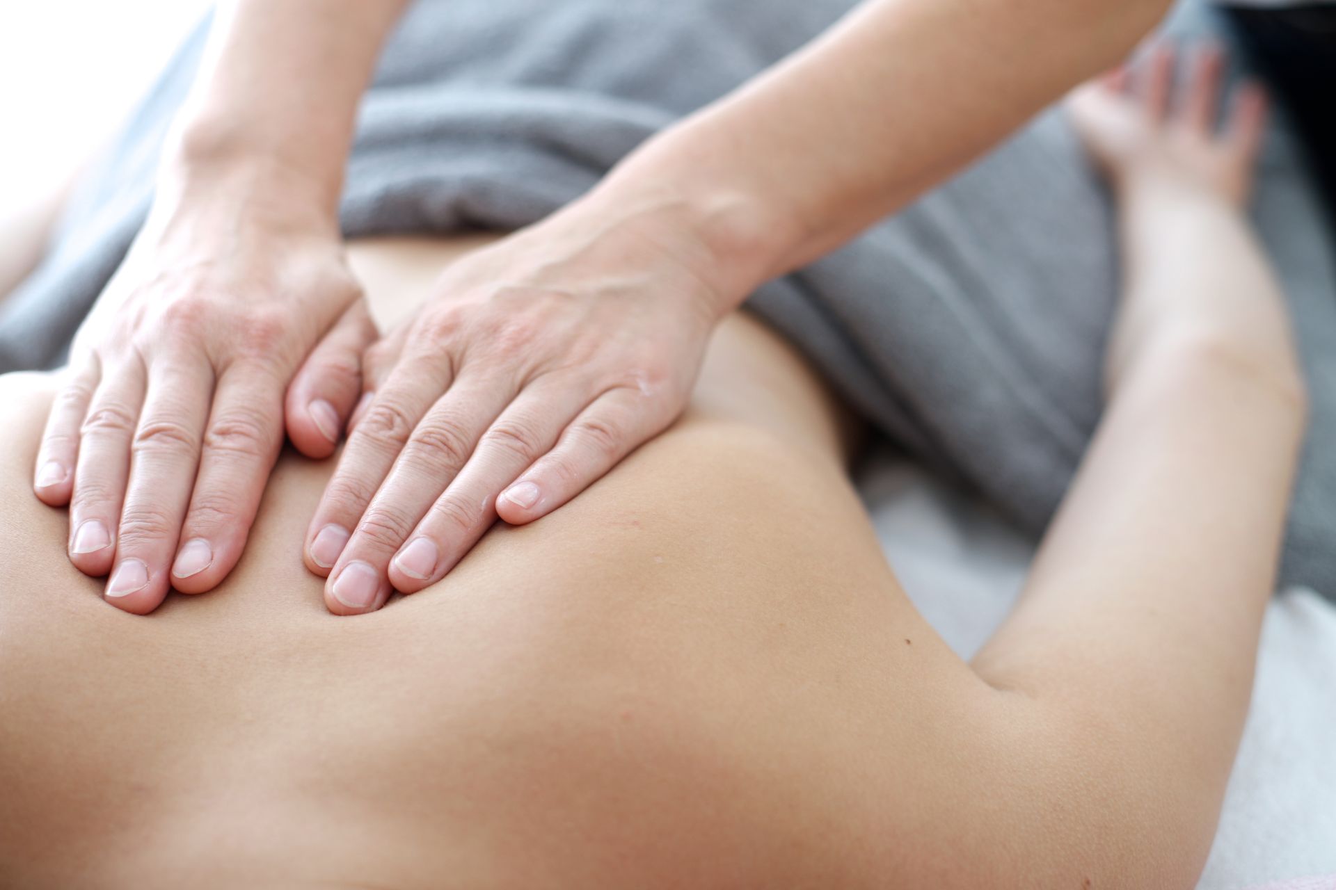 Close up of back massage procedure in spa salon.
