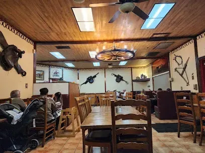 A restaurant with tables and chairs and a ceiling fan