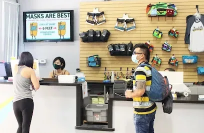 A man wearing a mask is standing in front of a counter in a store.