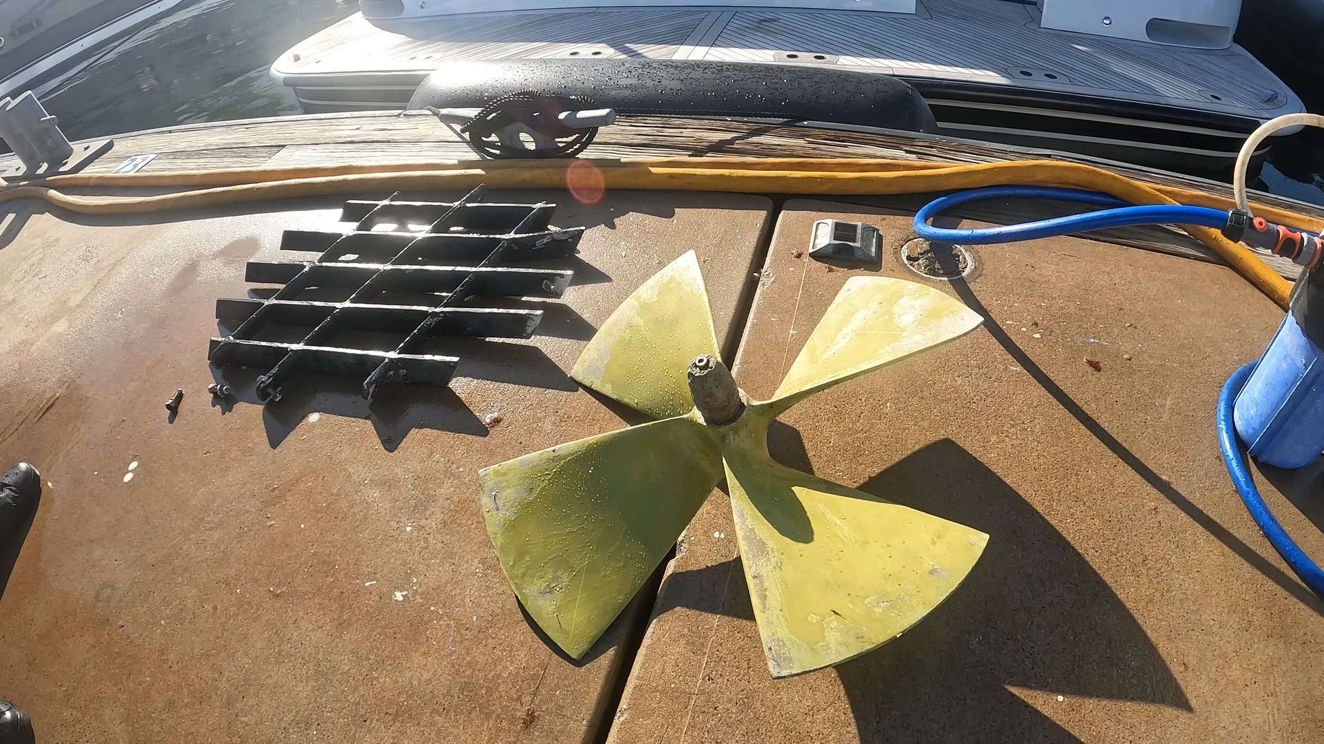 A yellow propeller is sitting on a concrete surface