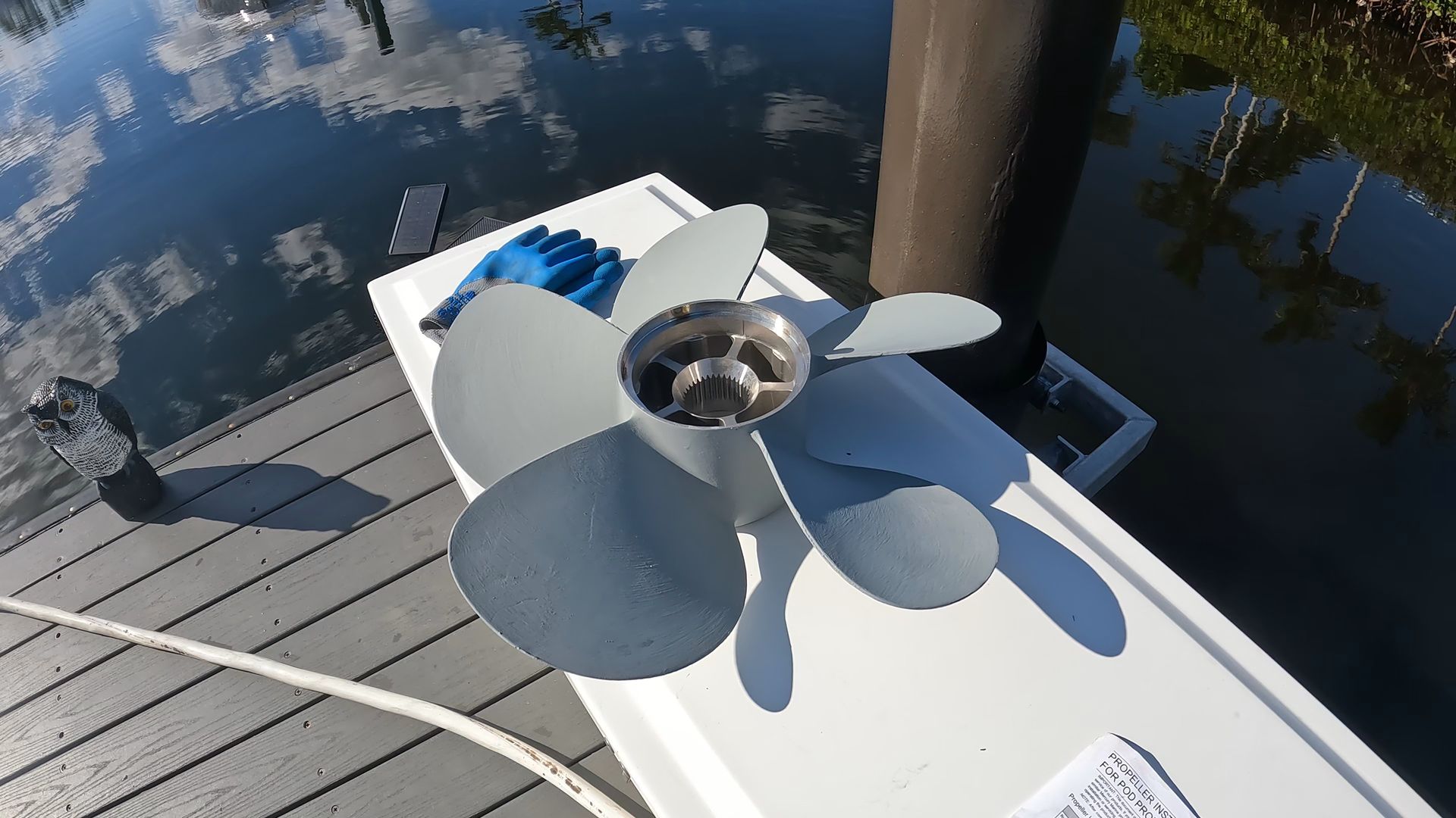 A propeller is sitting on the side of a boat