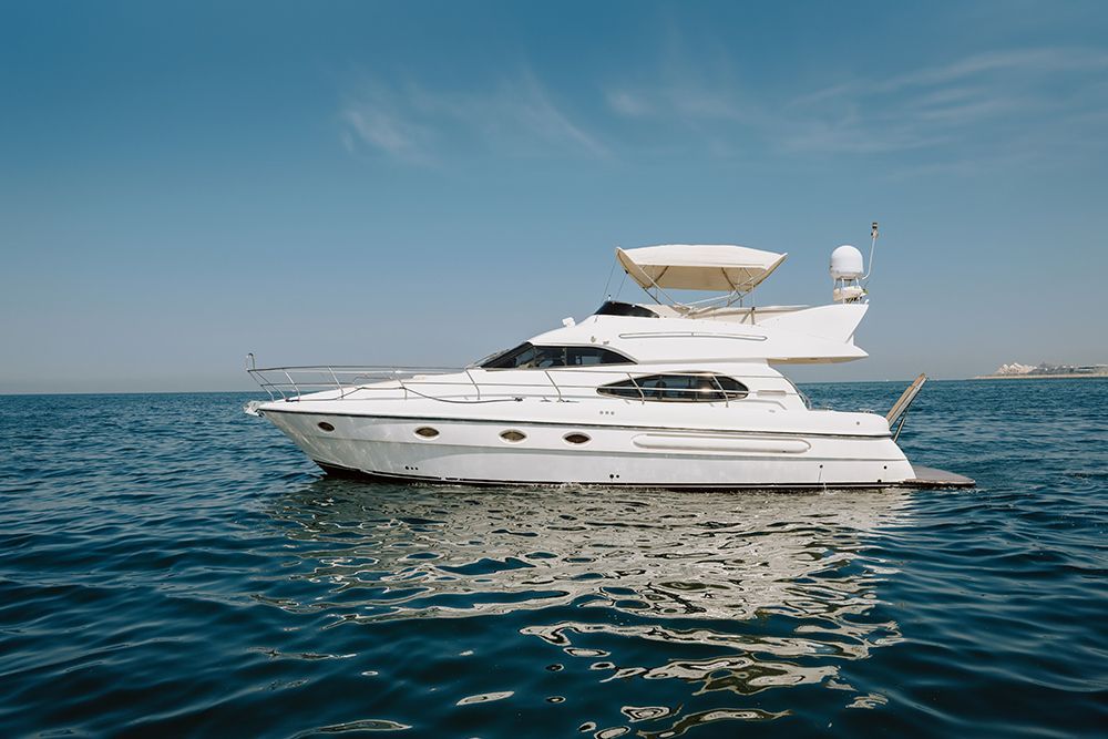 White yacht on blue water under a clear sky.