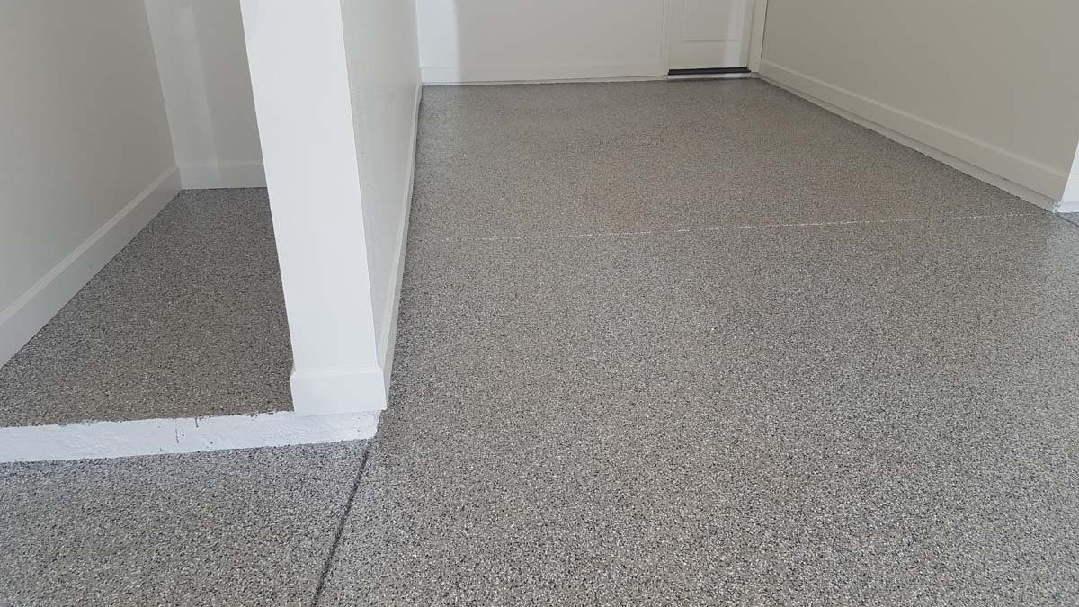 A room with a gray floor and white walls.