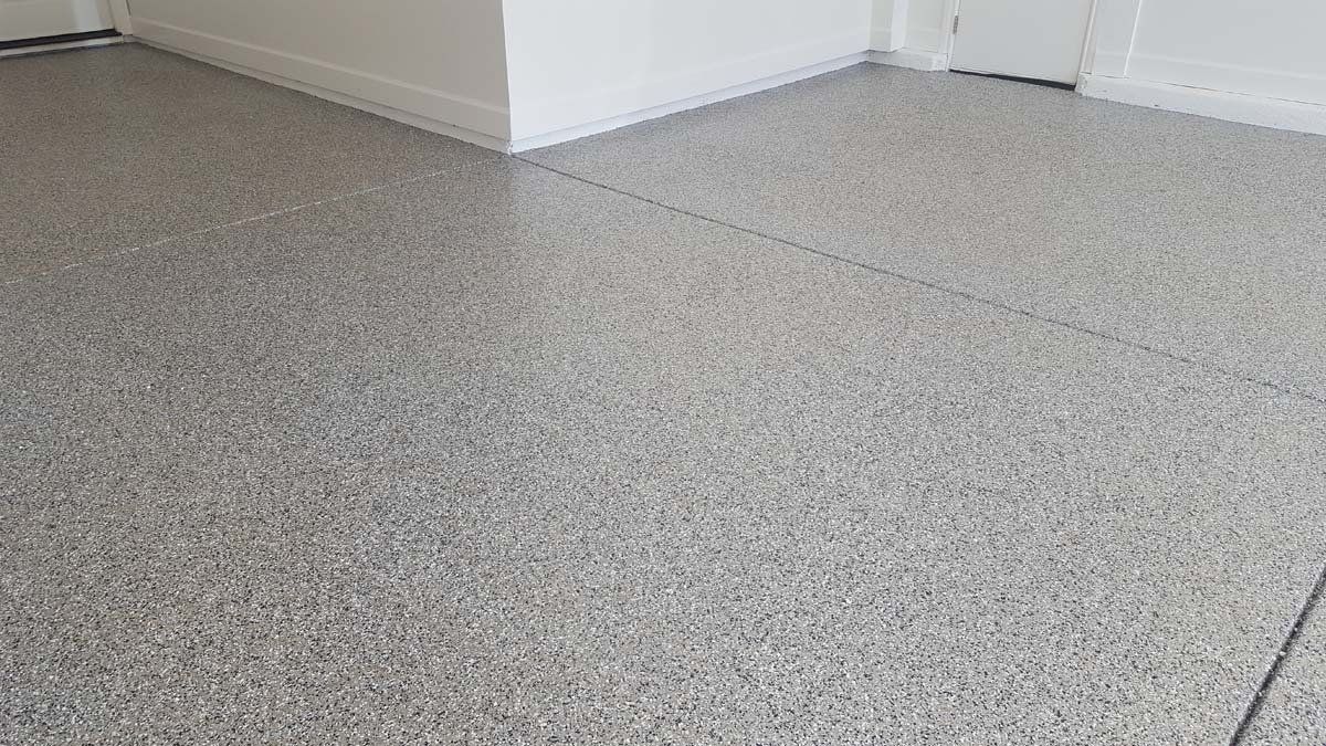A close up of a gray concrete floor in a room.
