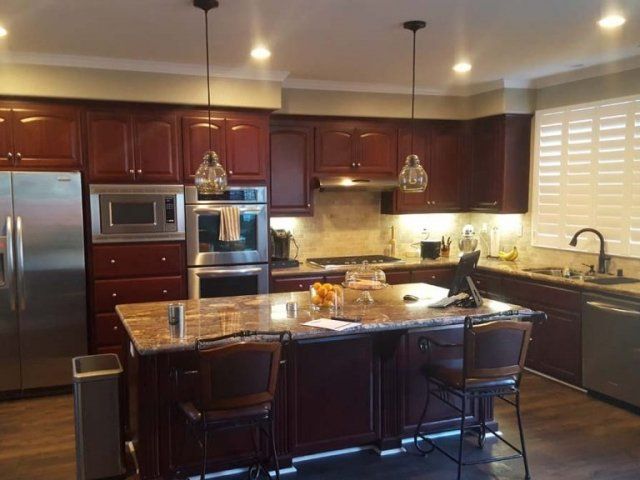 A kitchen with stainless steel appliances and wooden cabinets