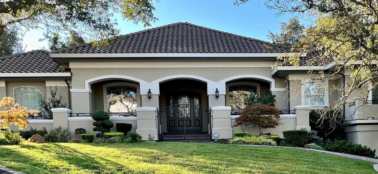 A large house with a lush green lawn in front of it.