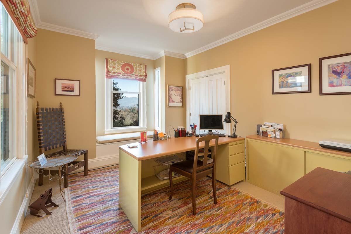 A home office with a desk , chair , and computer.