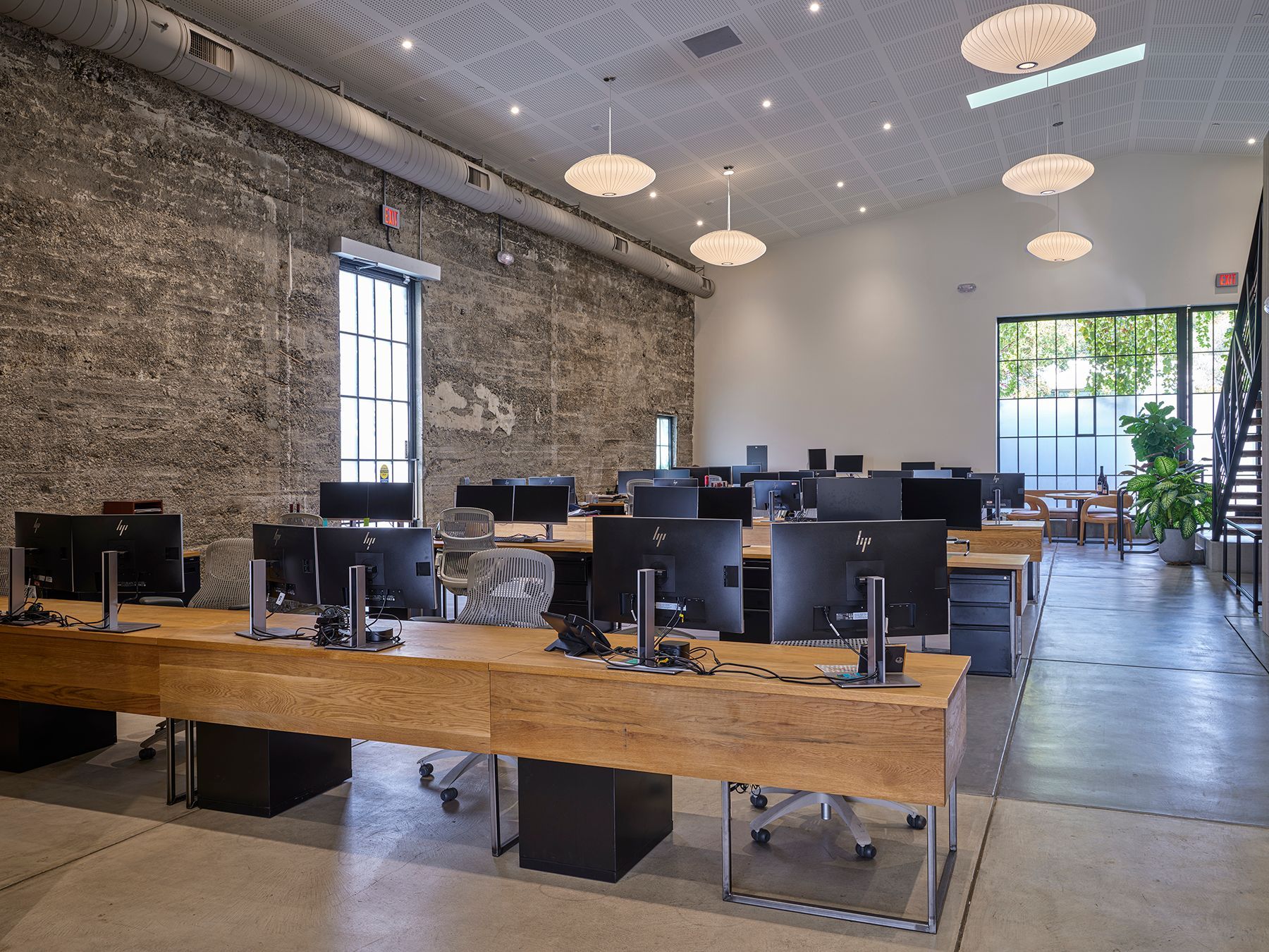 A large office with lots of desks and computers