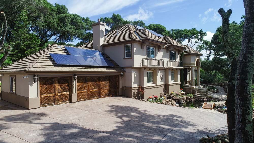 A large house with solar panels on the roof