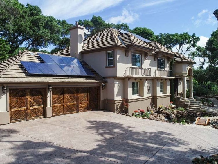 a large house with solar panels on the roof