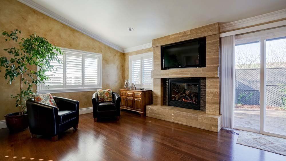There is a fireplace in the middle of the living room.