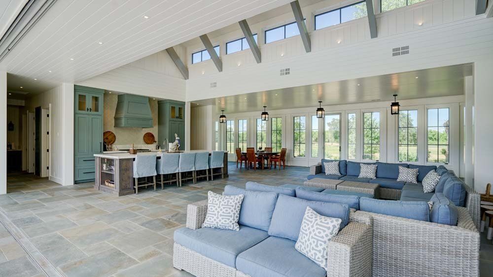 A living room with a lot of furniture and a kitchen