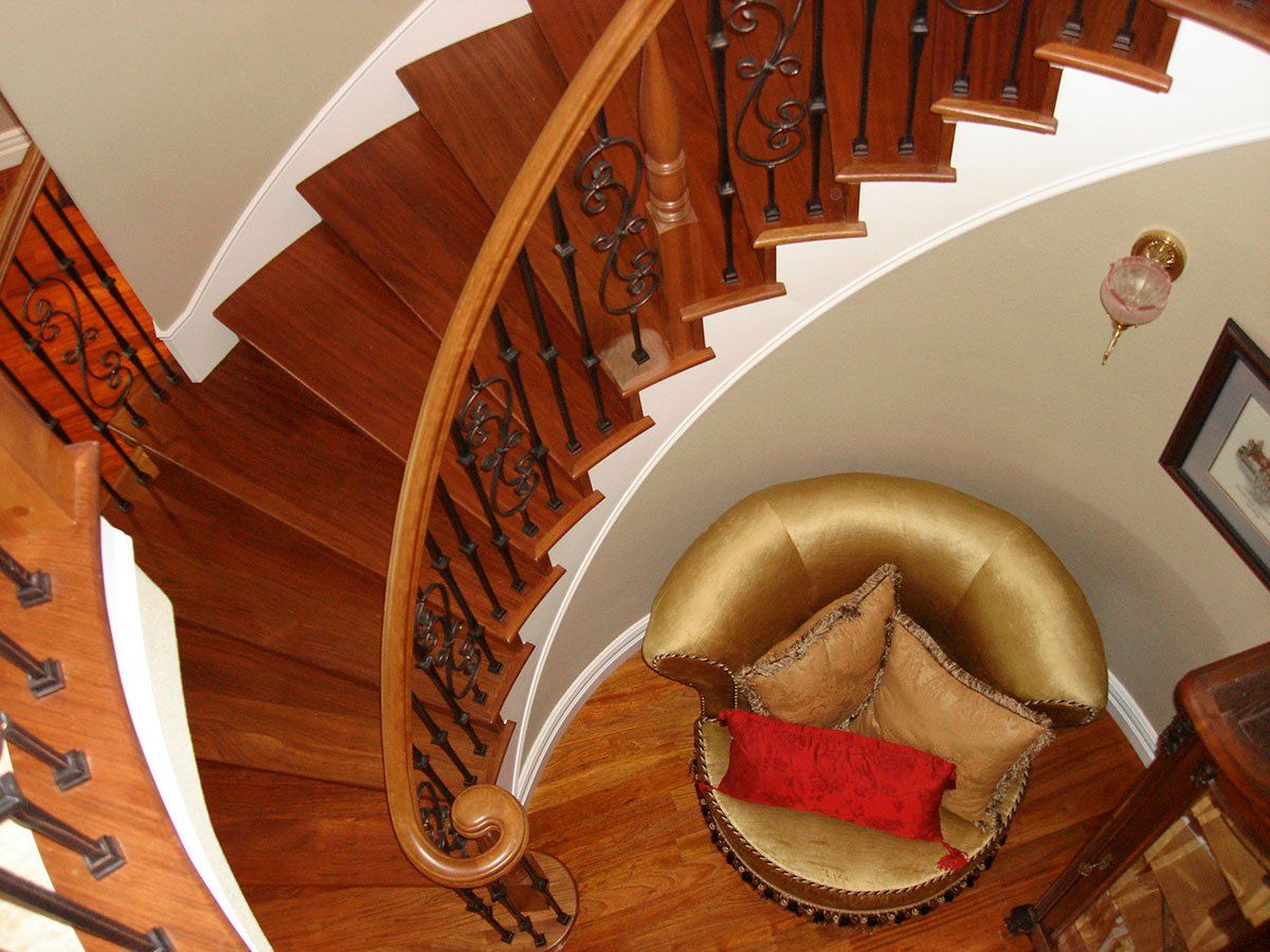 An aerial view of a curved staircase with a chair in the middle