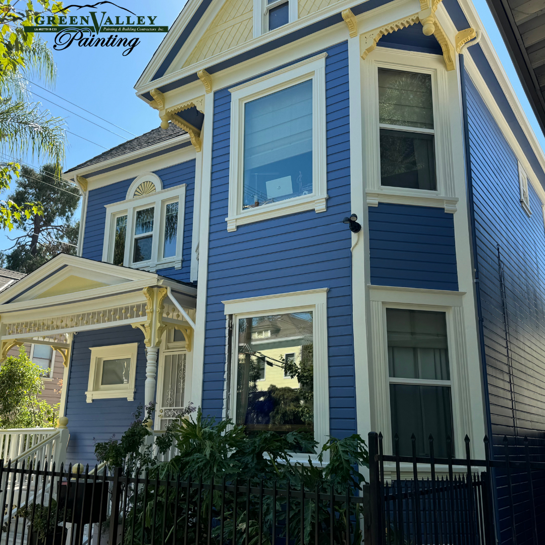 A blue and white house with the word painting on it