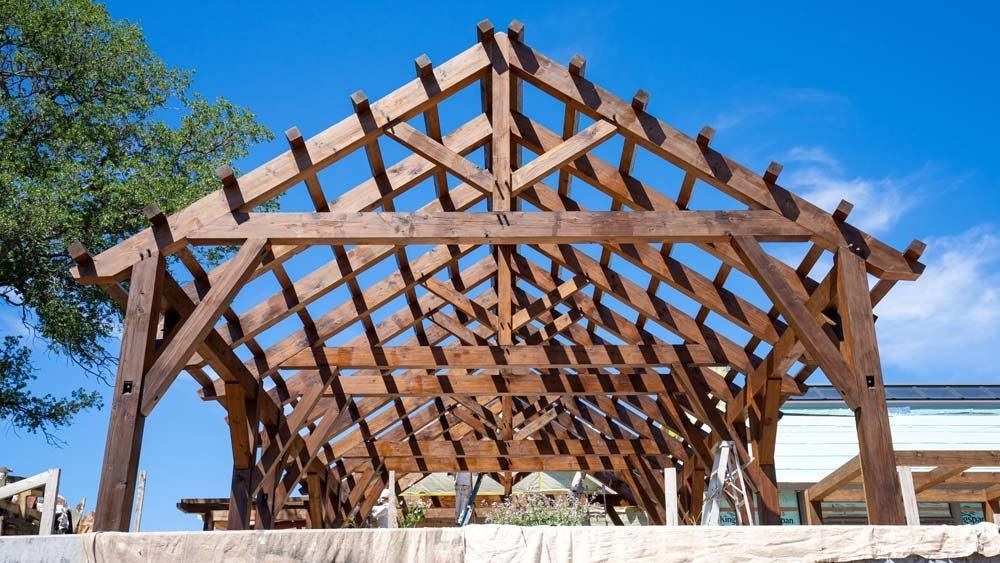 A large wooden structure with a blue sky in the background.