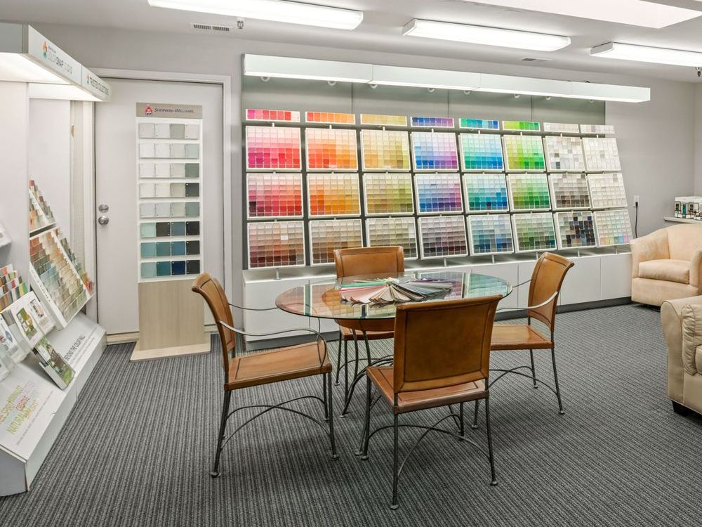 A living room with a couch and a table in a sherwin williams store