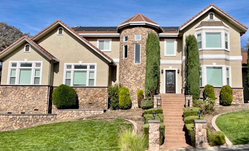 A large house with a lot of windows and stairs leading up to it.
