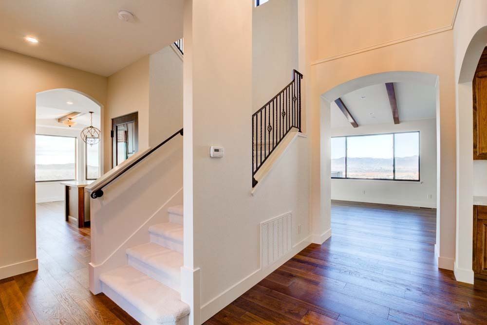 A hallway with stairs leading up to the second floor of a house.
