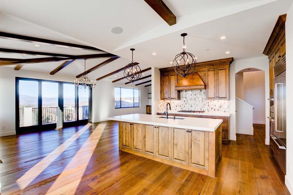 An empty kitchen with wooden cabinets and a large island