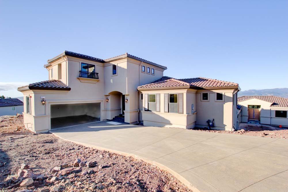 A large house with a concrete driveway leading to it