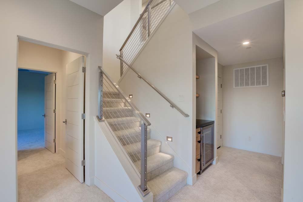 A hallway with stairs leading up to the second floor