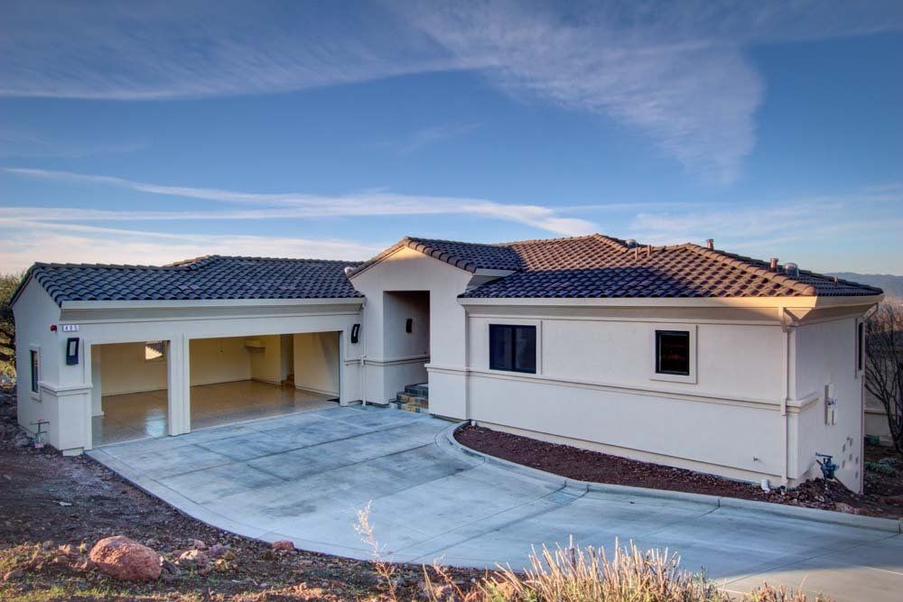 A large white house with a garage and a driveway.