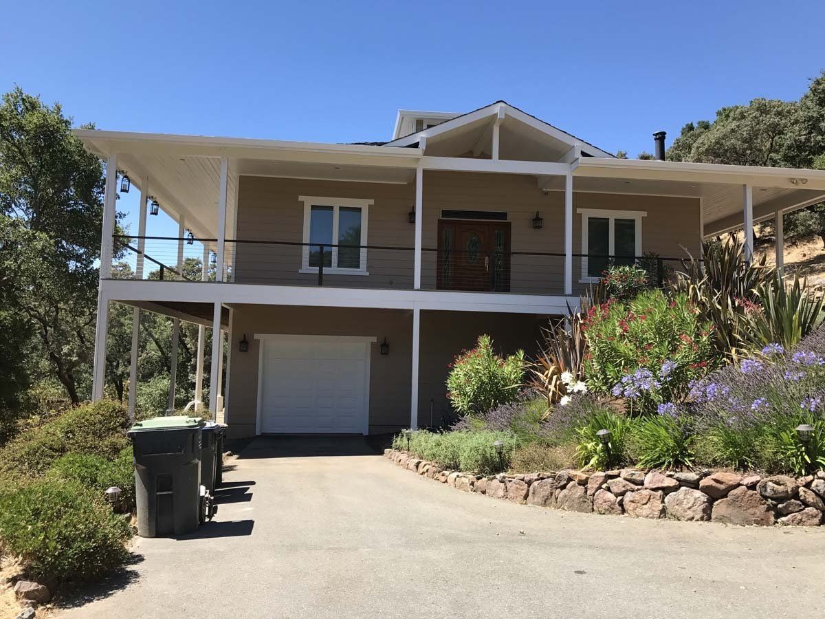 A large house with a garage and a balcony