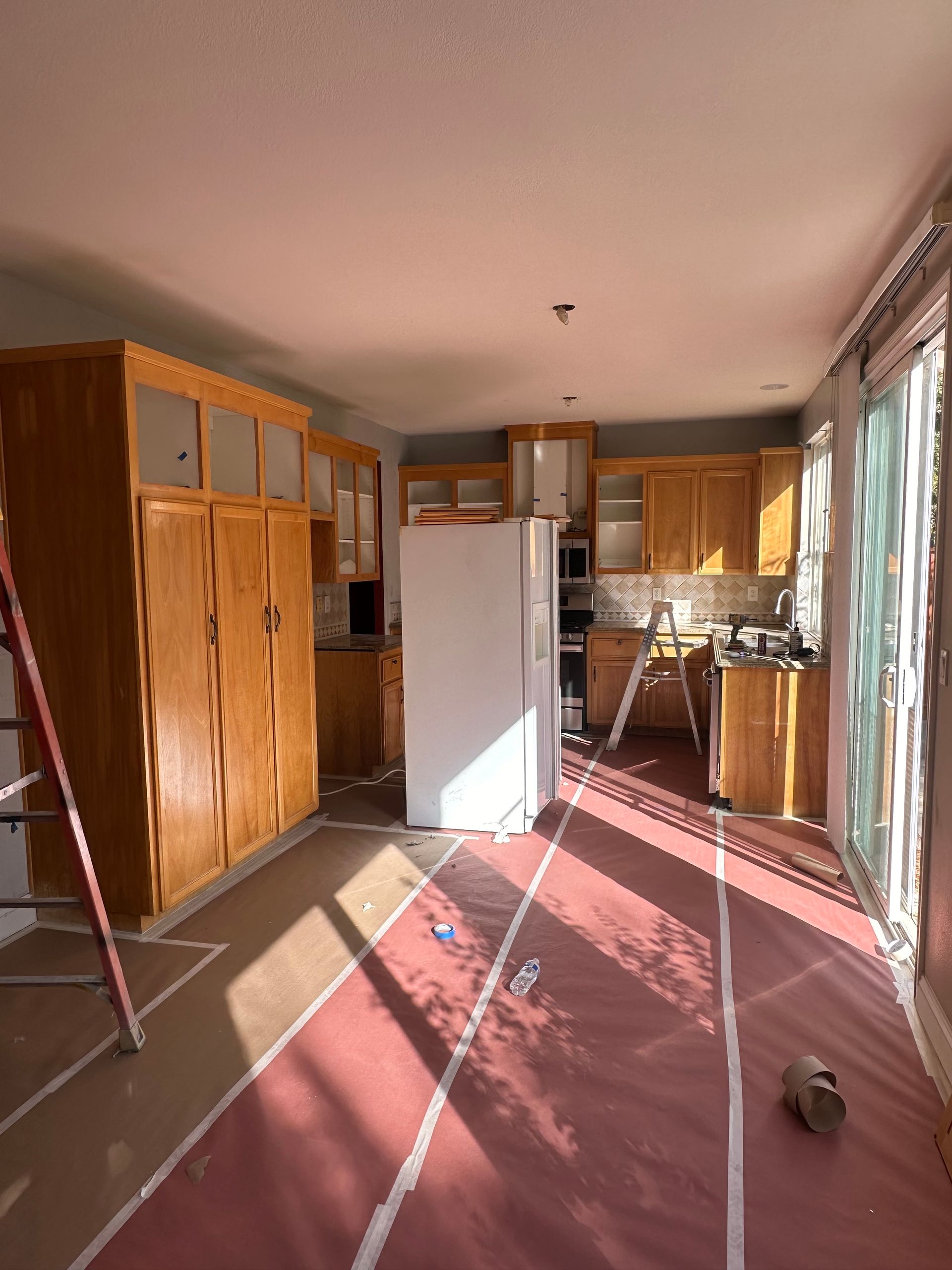 A kitchen with wooden cabinets and a white refrigerator