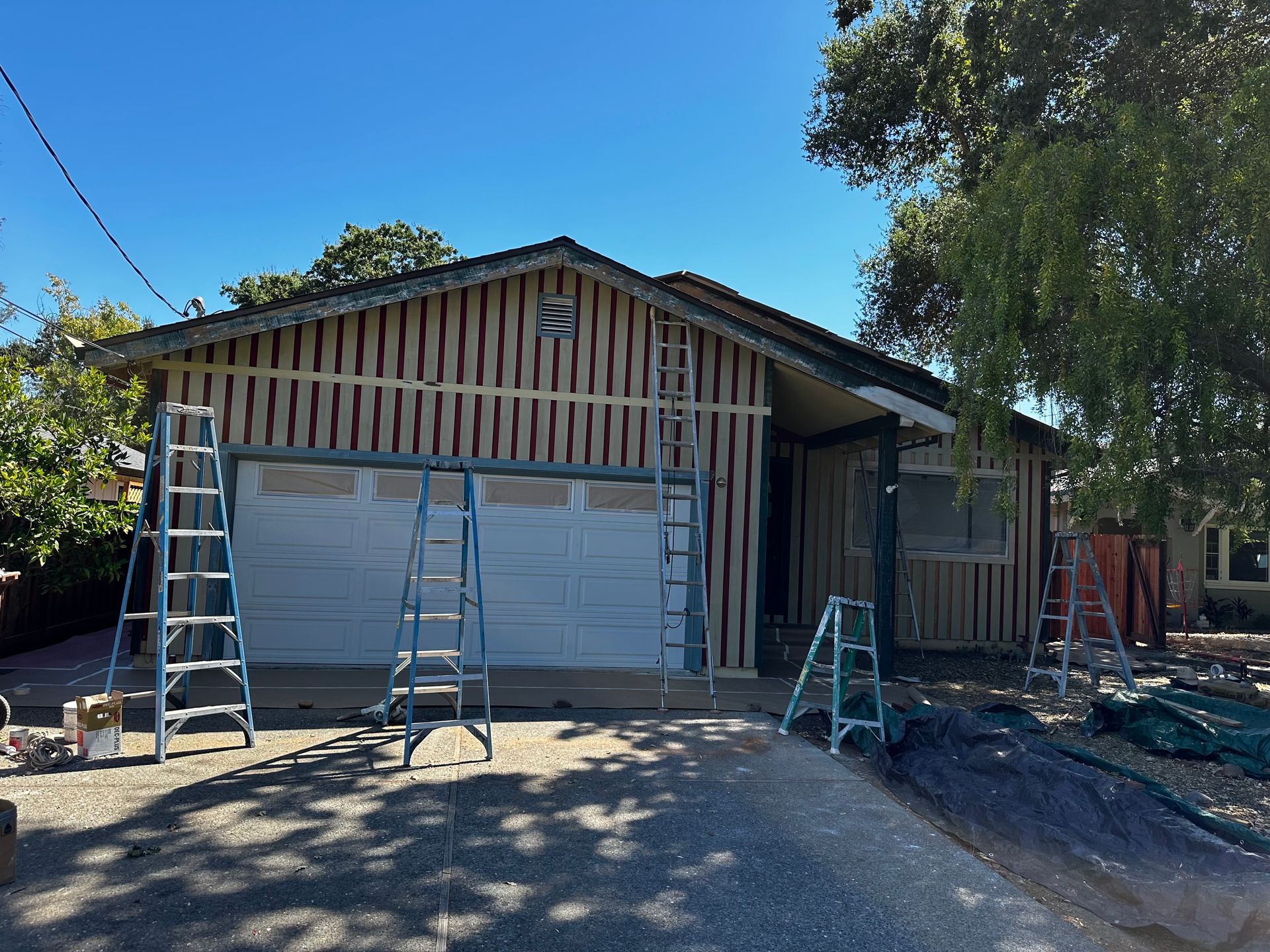 A house with a garage door is being remodeled